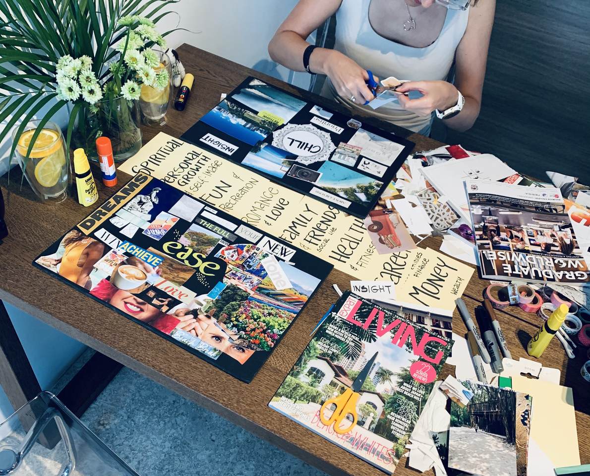 A table with collage materials, cut paper and images used in a creative supervision session